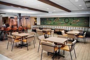 a restaurant with tables and chairs and a green wall at Fairfield Inn & Suites by Marriott Moab in Moab
