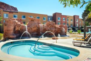 a pool with a water slide in a resort at Fairfield Inn & Suites by Marriott Moab in Moab
