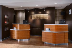 a lobby with two reception desks in a building at Courtyard by Marriott Fishkill in Fishkill