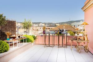 a balcony with a view of a city at Le Meridien Barcelona in Barcelona