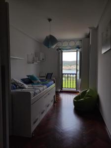 a bedroom with a bed and a large window at SOLPOR in Cee