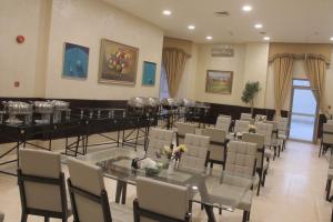 a dining room with tables and chairs in a room at Le Vendome Hotel in Amman