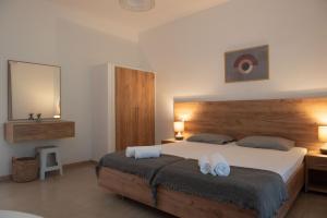a bedroom with a large bed with two towels on it at Tony's Garden House in Lefkimmi