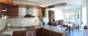 a kitchen with a counter top and a dining room at Appartamento Tennis in Cannero Riviera +13 photos