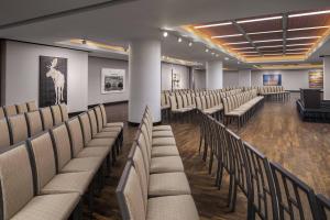 a row of chairs in a room with paintings at JW Marriott Houston Downtown in Houston