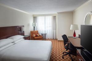 a hotel room with a bed and a desk and a computer at Indianapolis Marriott East in Indianapolis