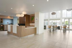 a lobby with a counter and tables and chairs at Element Austin Round Rock in Round Rock