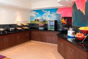 a restaurant kitchen with a counter with food on it at Fairfield Inn & Suites Cheyenne in Cheyenne