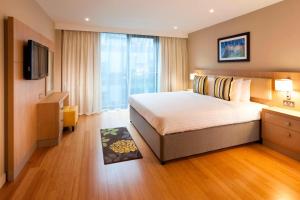 a hotel room with a bed and a flat screen tv at Residence Inn by Marriott Edinburgh in Edinburgh