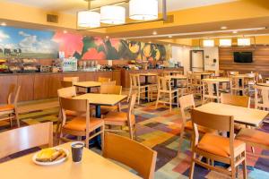 a restaurant with tables and chairs and a kitchen at Fairfield Inn Anaheim Hills Orange County in Anaheim