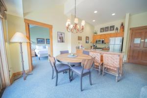 a kitchen and dining room with a table and chairs at Springs 8910 in Keystone