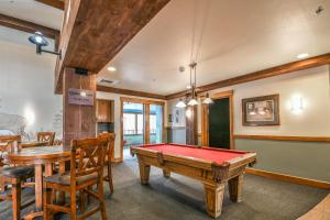 a pool table in a room with a table and chairs at Springs 8910 in Keystone