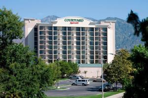 a large hotel with a sign on top of it at Courtyard by Marriott Los Angeles Pasadena/Monrovia in Monrovia