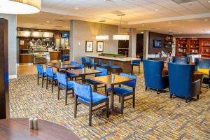 a dining room with tables and blue chairs at Courtyard by Marriott Los Angeles Pasadena/Monrovia in Monrovia
