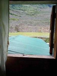 an open window with a view of a field at Batad Family Inn and Hidden Hut in Banaue