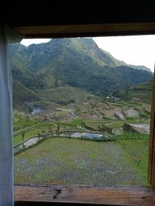 a view of a mountain from a window at Batad Family Inn and Hidden Hut in Banaue