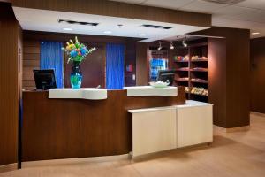 a lobby with a reception desk with a vase of flowers at Fairfield Inn by Marriott East Rutherford Meadowlands in East Rutherford