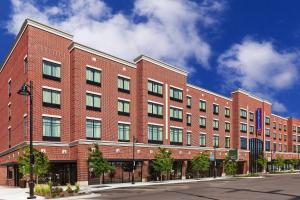 a large red brick building on a city street at Fairfield Inn & Suites Tulsa Downtown Arts District in Tulsa