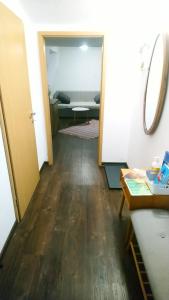 a hallway leading to a living room with a table at Apartment Room Old City - Apartment Slavija in Škofja Loka