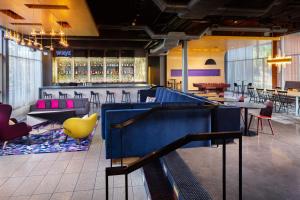 a restaurant with a ping pong table and chairs at Aloft Tempe in Tempe