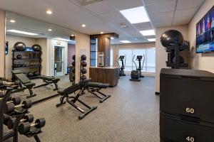 a gym with several treadmills and a flat screen tv at TownePlace Suites San Antonio Northwest at The RIM in San Antonio