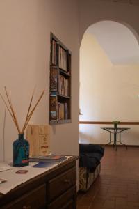 a living room with a book shelf and a table at Ferdinando II De' Medici in Florence