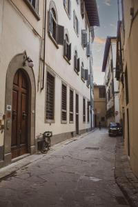 佛羅倫斯的住宿－Ferdinando II De' Medici，一条小巷,在街上有一座建筑和一辆汽车