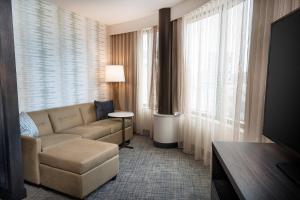 a living room with a couch and a large window at Residence Inn by Marriott Grand Rapids Downtown in Grand Rapids