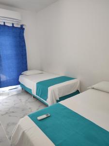 a room with two beds and a towel on the floor at Proyecto MOONLIGHT in Villavieja