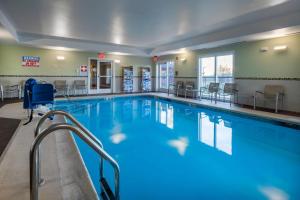 a large swimming pool with blue water in a building at SpringHill Suites Devens Common Center in Devens