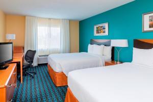 リーズ・サミットにあるFairfield Inn & Suites Kansas City Lee's Summitのベッド2台、薄型テレビが備わるホテルルームです。