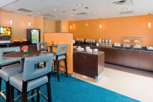 a restaurant with a bar with a food counter at Residence Inn by Marriott Dallas Lewisville in Lewisville