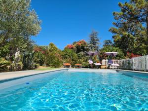 a swimming pool with blue water in a yard at Casa San Niolo in Cervione