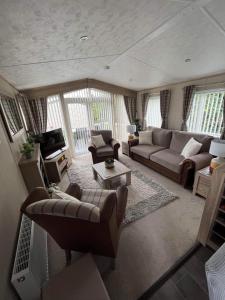 a living room with a couch and a table at The Helmsley lodge lido beach Prestatyn northwales in Prestatyn