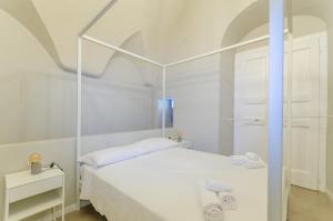 Letto o letti in una camera di Palazzo Junno Dimora D'Epoca