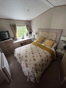a bedroom with a large bed and a window at The Helmsley lodge lido beach Prestatyn northwales in Prestatyn
