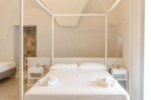 Letto o letti in una camera di Palazzo Junno Dimora D'Epoca