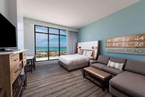 SpringHill Suites by Marriott Navarre Beach في نافار: غرفه فندقيه سرير وتلفزيون