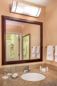 a bathroom with a sink and a large mirror at SpringHill Suites Laredo in Laredo