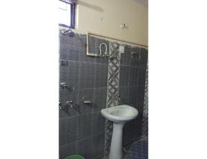 a bathroom with a toilet and a shower at Hotel Gaurishankar Palace, Barkot in Barkot