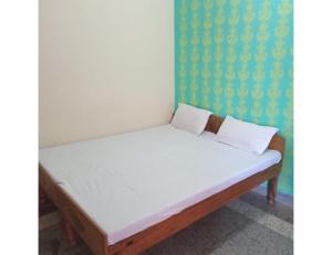 a bed in a room with a white mattress at Hotel Gaurishankar Palace, Barkot in Barkot