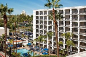 an apartment building with a pool and palm trees at Fairfield by Marriott Anaheim Resort in Anaheim