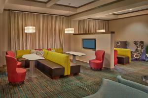 a waiting room with couches and tables and chairs at Residence Inn by Marriott Hartford Downtown in Hartford