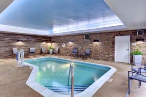 a pool in a room with chairs and a brick wall at Fairfield Inn & Suites by Marriott Nashville Downtown-MetroCenter in Nashville
