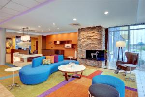 a living room with a blue couch and a fireplace at Fairfield Inn & Suites by Marriott Nashville Downtown-MetroCenter in Nashville