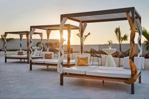 a group of four beds sitting on a patio at Residence Inn by Marriott Playa del Carmen in Playa del Carmen