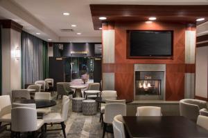 a restaurant with tables and chairs and a fireplace at Residence Inn Memphis Downtown in Memphis