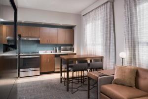 a kitchen and living room with a couch and a table at Residence Inn Memphis Downtown in Memphis
