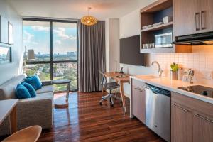 a kitchen and living room with a couch and a table at Element Fort Lauderdale Downtown in Fort Lauderdale