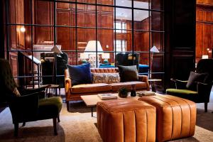 a living room with a couch and a table at The Adolphus, Autograph Collection in Dallas